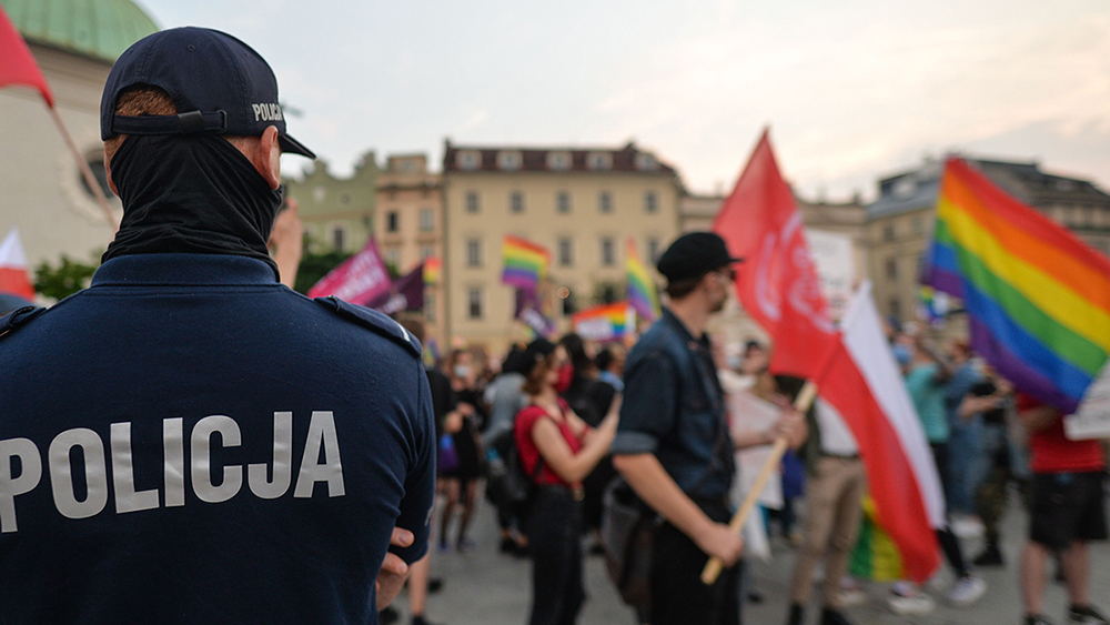 Polish police and people with pride flags.