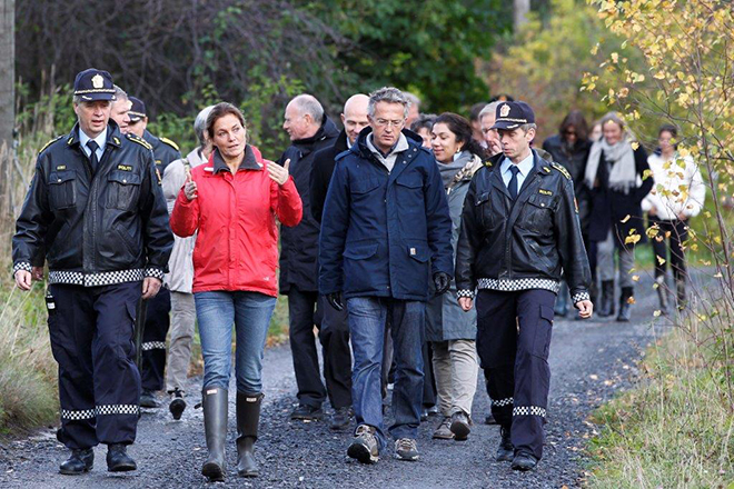 A group of people including two police officers walking on a path.
