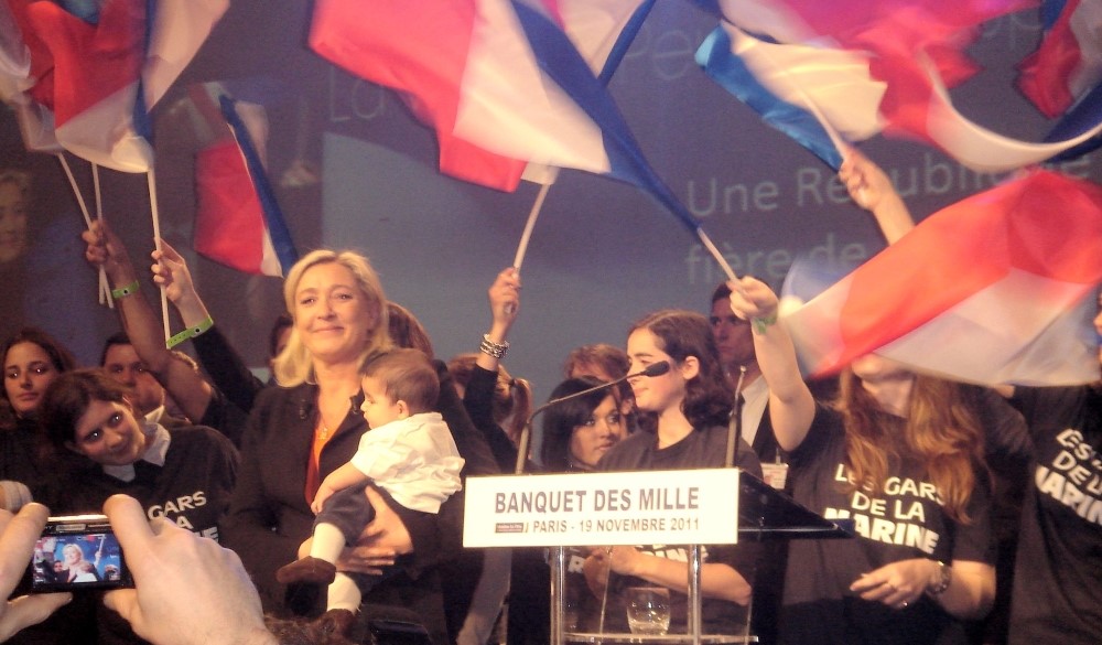 A photograph of Marine Le Pen, supporters and French flags