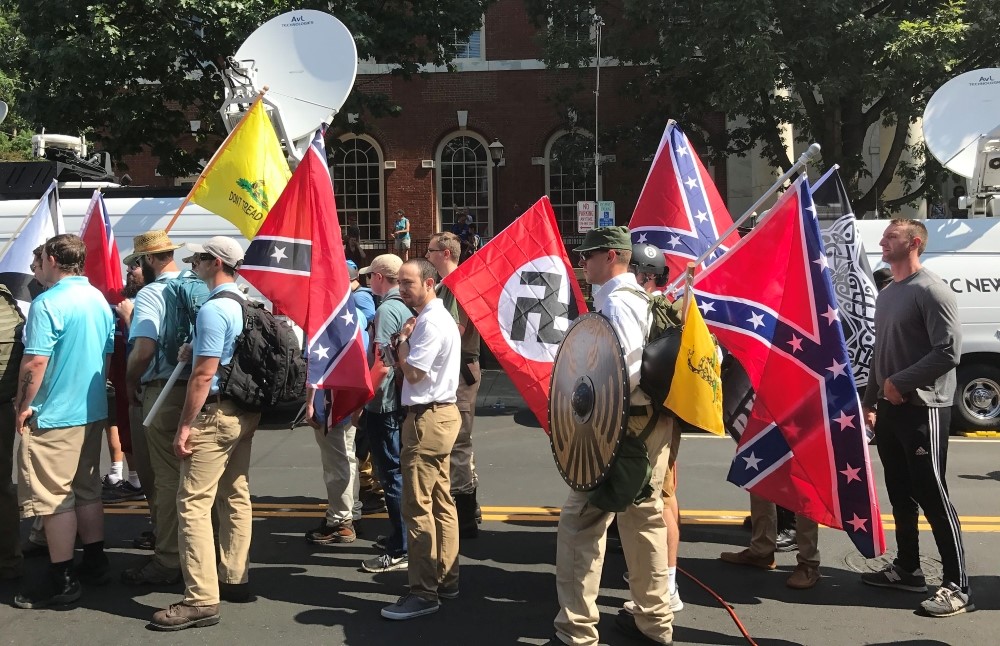 Alt-right members holding Nazi, Confederate Battle, Gadsden "Don't Tread on Me," League of the South, and Thor's Hammer flags.