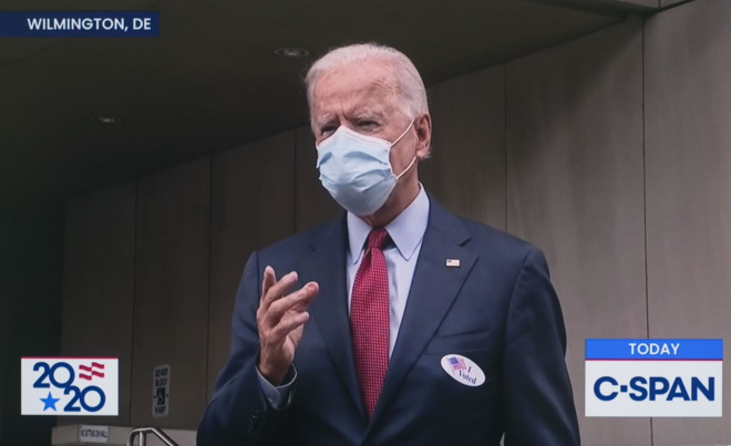 American President Joe Biden wearing a face mask during a TV interview.