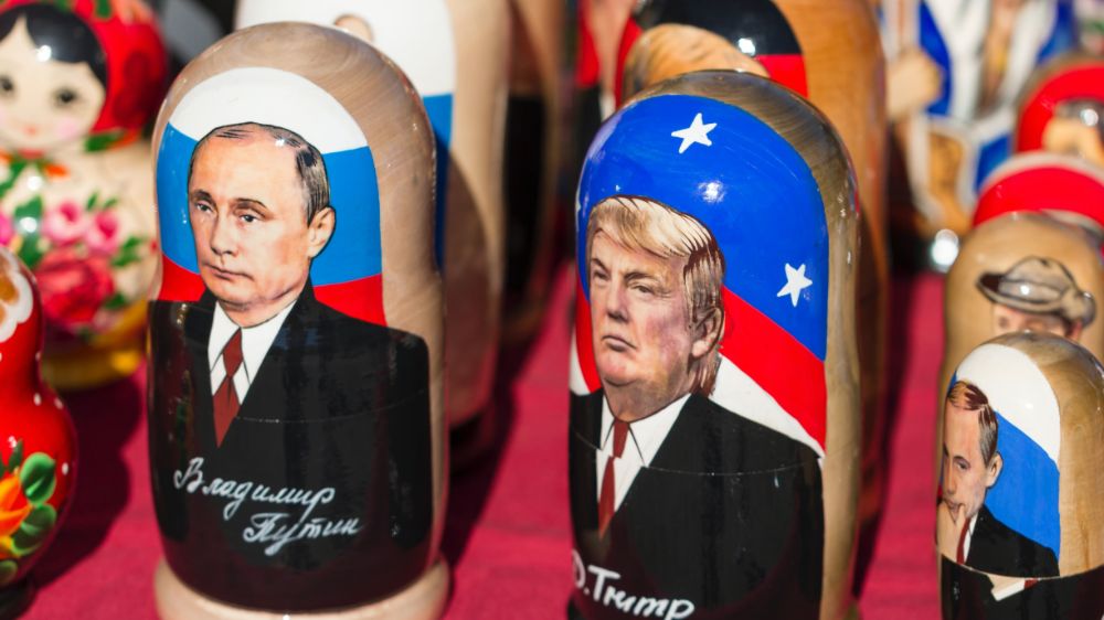 Wooden figures with pictures of Vladimir Putin and Donald Trump.