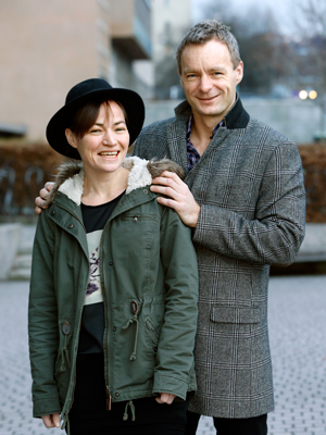 Two smiling people standing outside; Kristine Walhovd and Anders Fjell.
