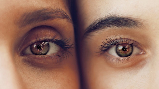 close-up of two people's eyes, side by side