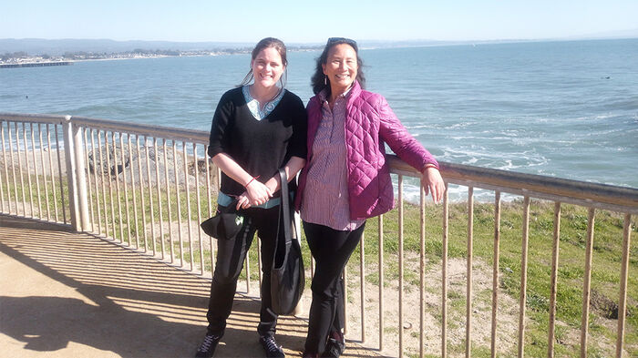 Jess Auerbach and professor Nancy Chen standing by the coast