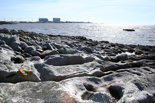 Beach of irregular stones.